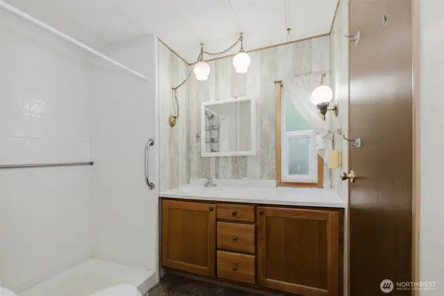 Updated bathroom with walk-in shower can be accessed from the hallway as well as from the Primary bedroom.