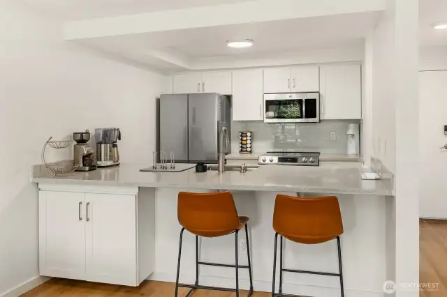 Refreshed, modern kitchen with bar seating perfect for dining.