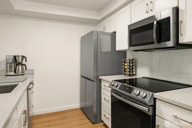 A sleek backsplash compliments upgraded appliances.