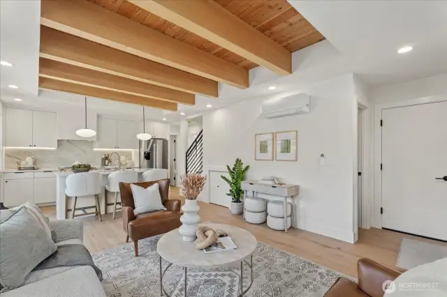 Living room.  Powder room under the stairs.  Garage door on the right hand side.