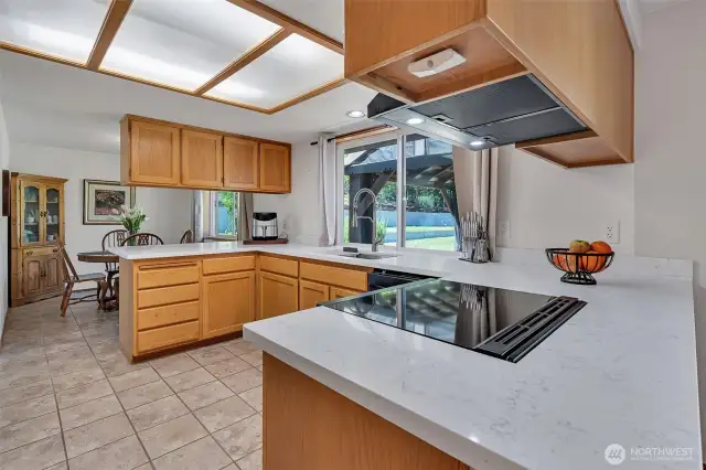 Easy Maintenance Quartz Counter and Tile Laminate Floors in Kitchen.