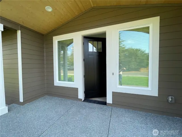 Large front entrance with surrounding huge windows and door.