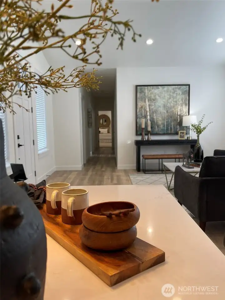 Kitchen island looking down the hallway to the master bedroom at the end.