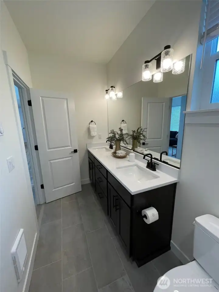 Primary bath with shower and double sinks.