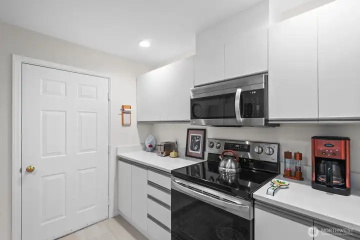 Electric stove and microwave with hood vented to outside.