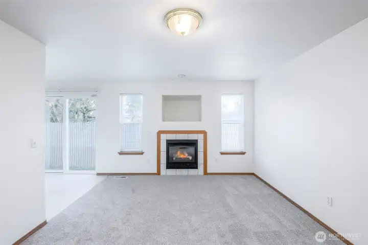 Gas fireplace in living room with space for television or decor