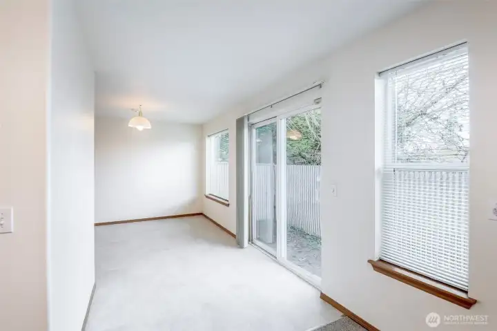 Dining and sliding glass door to back of condo