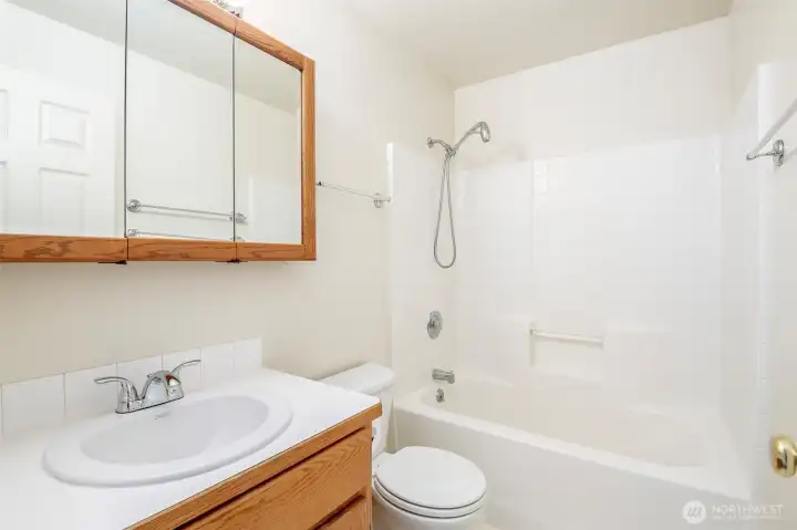 Secondary full bath on upper floor with new sink and faucet