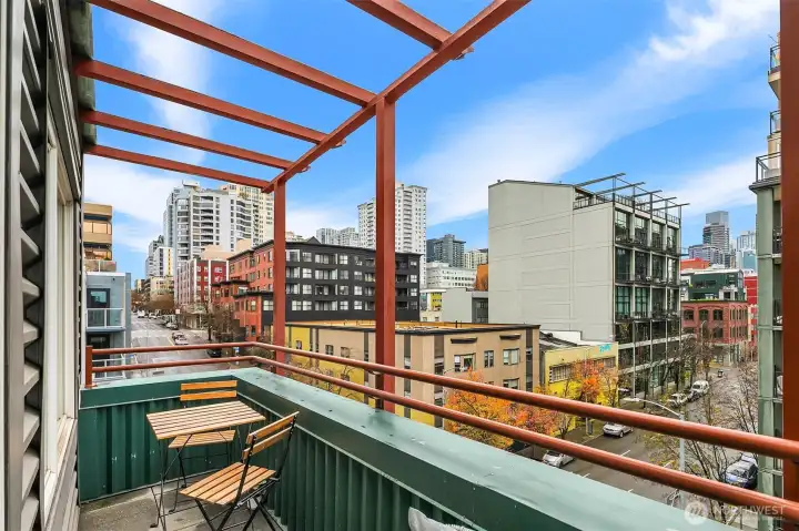 Large private patio off living space. Cool city and water view.