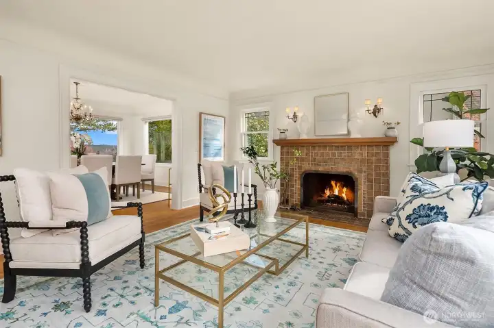 Spacious living room with gas fireplace, crown molding and lots of light.