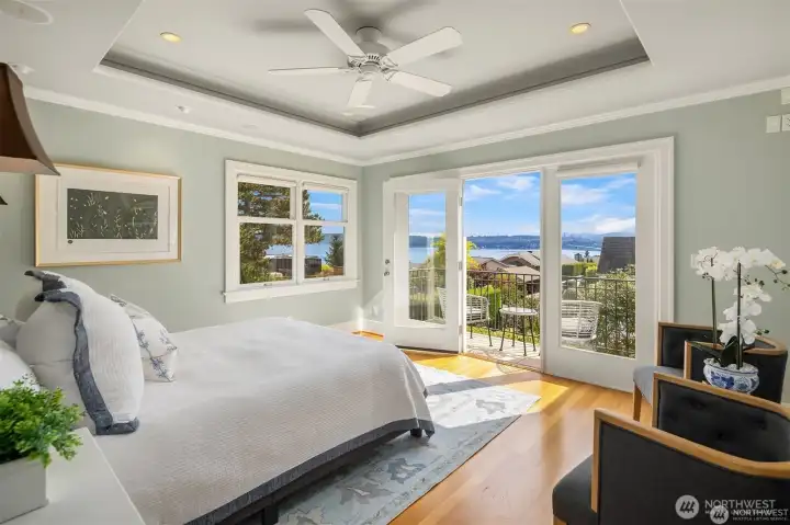 Upper level primary suite with French doors and Juliet balcony.