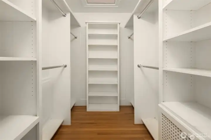 Primary walk-in closet with access to full size attic with tons of storage and flexible space to use for desk, or exercise.
