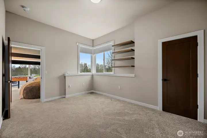 Additional bedroom in this River Rock home in Auburn features a bright layout with large windows, soft carpeting, and flexible space for guests, family, or a home office. The comfortable design provides privacy and easy access to nearby bathrooms and living areas.