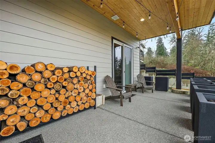 Covered back patio in this River Rock home in Auburn features a spacious outdoor seating area with wood ceiling accents and lighting, creating a comfortable space for relaxing or entertaining while enjoying the peaceful backyard setting. Covered back patio in this River Rock home in Auburn features a spacious outdoor seating area with wood ceiling accents and lighting, creating a comfortable space for relaxing or entertaining while enjoying the peaceful backyard setting.