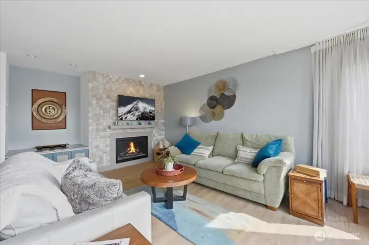 Natural lighting and neutral palette with custom one of a kind tile waterfall fireplace surround.  Peaceful setting to enjoy in all seasons.