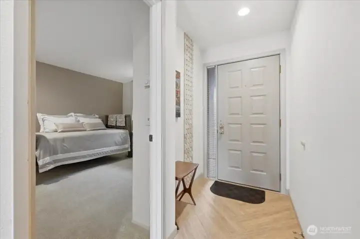 East facing front door to this waterfront treasure.  Custom touches throughout give you a one of a kind living experience. Roomy guest room featured on the left.