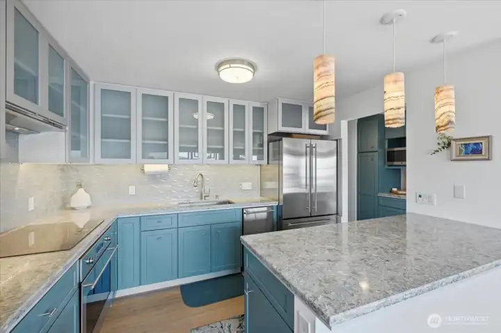 Double deep cabinet breakfast bar for a quick bite or that perfect party spread.  Overhead custom light fixtures highlight the space shared between the dining room and kitchen space.   Take a peek at the pantry and butlers pantry space just across the hall.