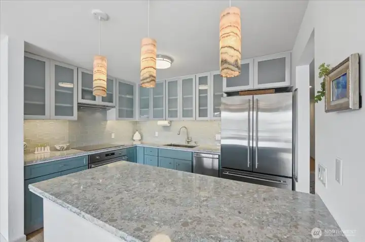 Kitchen Floor plan designed to have room to move around and cook for friends and family.  Full size fridge and Oven with induction cook top are perfect in this kitchen remodel if you are just two or more. Updated custom lighting and fixtures are the bow on a nicely updated kitchen.