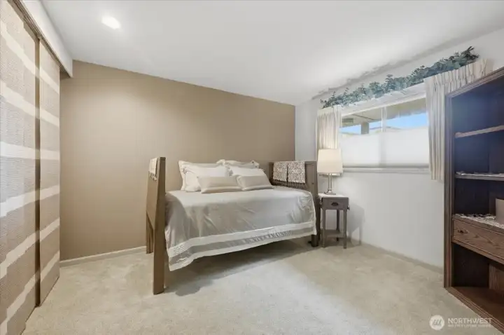 Enjoy the 2nd bedroom with neutral tones and closet with built in custom closet space & storage with cloth panel doors.  East facing windows offers atural lighting and views into courtyard with Japanese gardens interior courtyard sights and sounds.