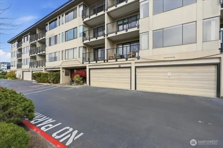 Western facing deck and wall of windows near the front entrance. Temporary power line for contractor project work draped just below deck and windows. Final project work underway.
