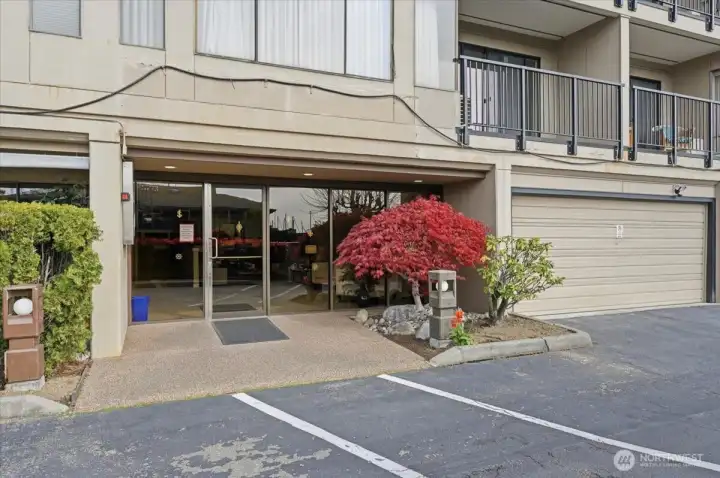 West facing front lobby. Covered and secured access and Lobby. Intercom and Key access . Inside are the postal boxes and elevator and stair access to all levels, storage and garage.