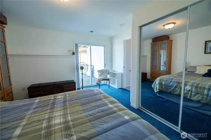 basement bedroom with sliders to patio