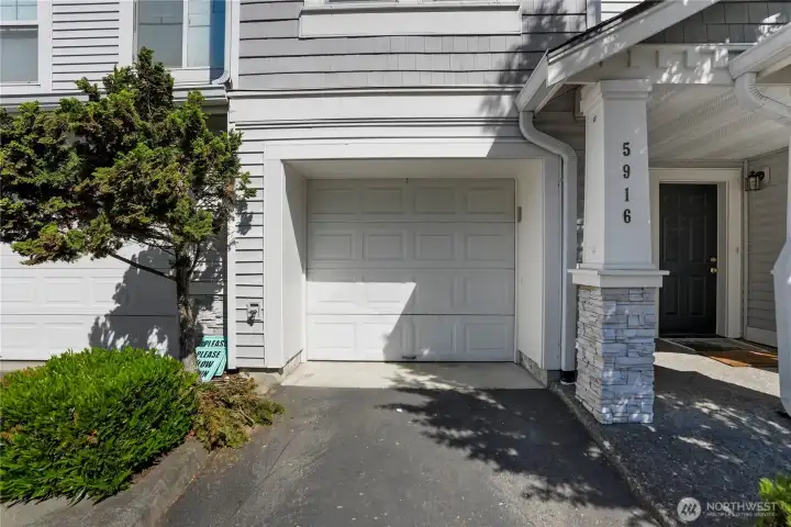 Spacious tandem garage provides room for two vehicles plus additional storage and organizational space.