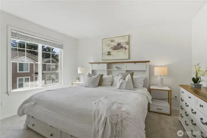 Unwind in the generously sized primary bedroom with abundant natural light.