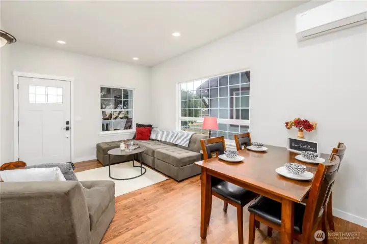 Cozy living room with large windows for plenty of natural light. Cozy living room with large windows for plenty of natural light.