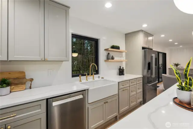 we can't get enough of this kitchen space, and you won't either once you see it in person! This kitchen is a dream and has all the makings for any chef...beautiful appliance package, farmhouse sink, brushed gold hardware, designer lighting, Bedrosian tile, and that quartz countertop is perfect in every way.