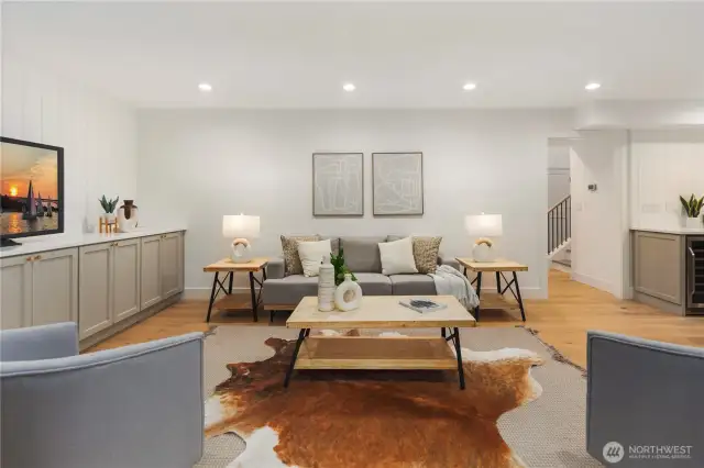 Tons of opportunity to create a fun space for everyone to gather...the palette in here is serene with the wide plank oak floors to the built in entertainment wall.
