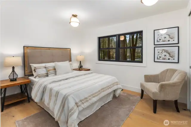 Bedroom 1...this room overlooks the front yard and has beautiful lighting over head, large closet with custom closet organizers and wide plan oak hardwoods. It's cozy, spacious and the perfect place to rest or use as an office space.