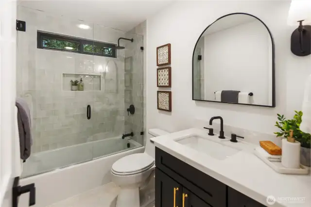 The hall bath is pretty dreamy as well, its brand new and no expense was spared. The custom vanity, the lighting and mirror, the Bedrosian Tiled bath surround and that hexagon tiled floor complete this space.