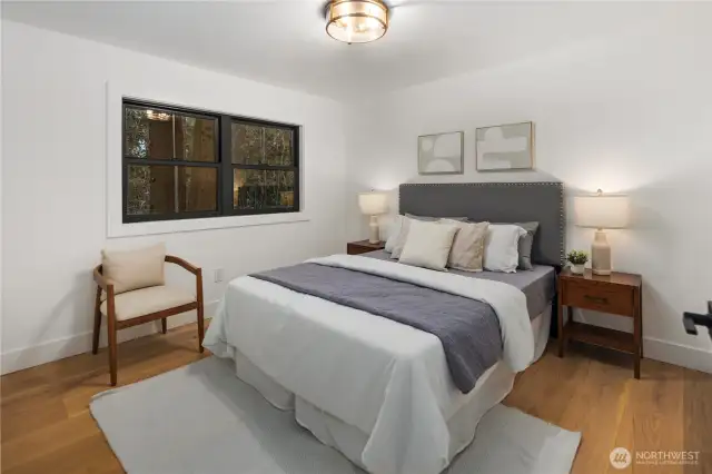 Bedroom 2- this upstairs room is tucked in the corner overlooking the rear yard with tons of privacy, custom built-in closet organizers, wide plan oak hardwoods and again more beautiful lighting fixtures to finish off this space.
