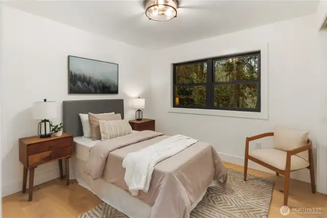 Bedroom 3- This room is perfectly sized and overlooks the expansive backyard, it has custom closet built-ins, wide plan oak hardwoods, and beautiful lighting to make it shine!