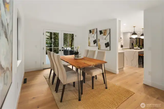 The formal dining offers french doors onto the expansive new deck overlooking your massive property.