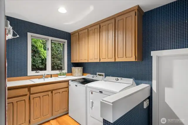 Convenient utility room adjacent to the kitchen and garage entrance.