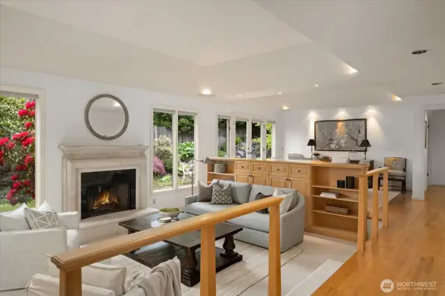 Spacious living room with gas fireplace and  built-ins adjacent to the dining room. New carpet.
