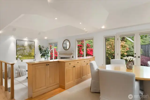 Dining room with French doors opening to the backyard patio with waterfall and pond with goldfish.