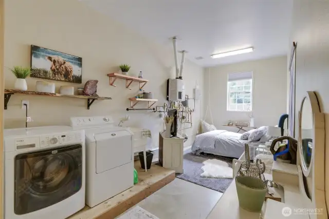 Laundry room with extra bed for overflow company