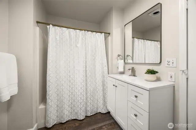 Downstairs full bath off kitchen, new vanity, mirror and lighting