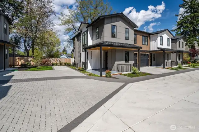 Parking pad to the left of this Townhome is assigned to Unit A as well as one car garage.