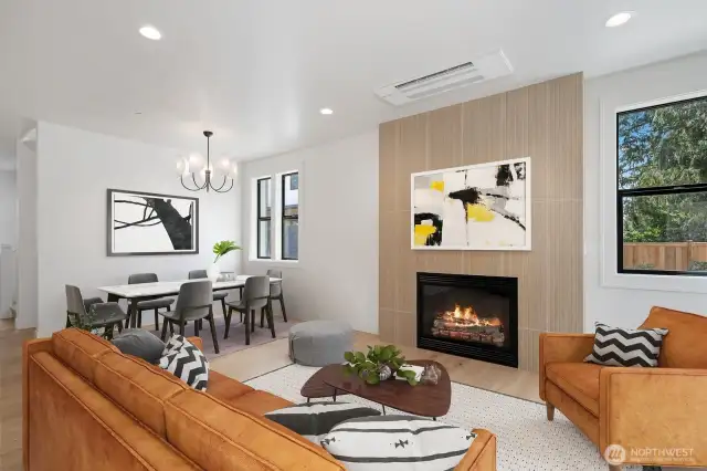 Family room opens to the dining room with designer chandelier