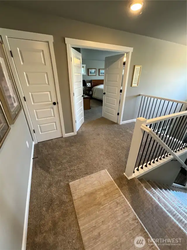 Upper floor hallway with view of front entry