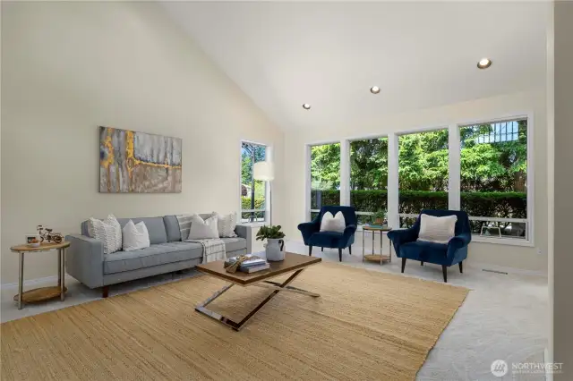 Living room boast ample natural light large picturesque windows looking to the large private backyard and inlet.