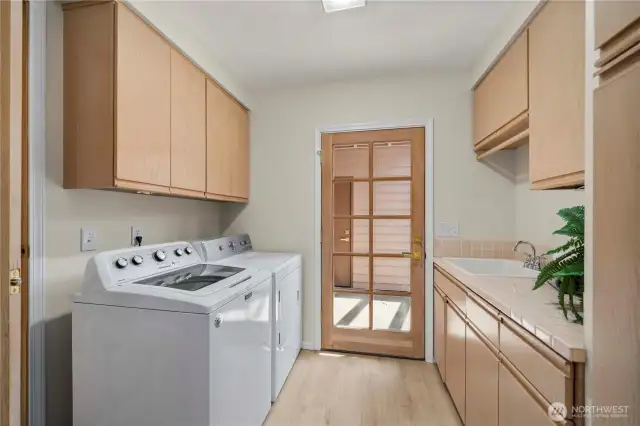 Laundry room with ample storage.