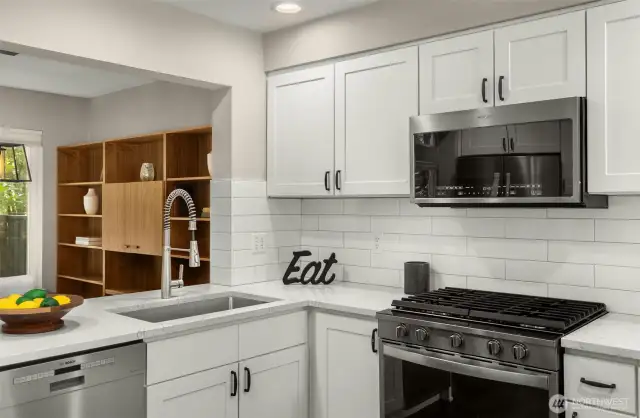 Premium SS appliances, quartz counters and stylish backsplash