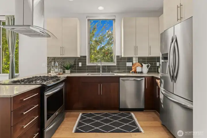 Stainless steel appliances and quartz counters in the large kitchen