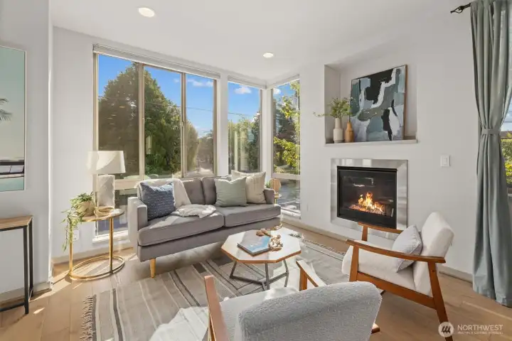 Generous living space highlighted by a gas fireplace and wall of windows