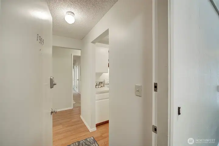 Welcome into the home! Through the front door and into the foyer, the kitchen is on the right and the bathroom is on the left, plus there is a large closet just ahead on the left.  Note the beautiful floors!
